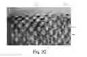 Fig. 14 - Nonwoven Material Having Discrete Three-Dimensional Deformations Forming Protrusions Having A Varying Width And Wide Base Openings